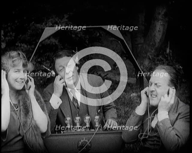 Comedian Harry Tate Sitting With One Female Civilian and One Male Civilian Listening to The..., 1924 Creator: British Pathe Ltd.