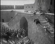 Scene from a Film: Actors Playing British Troops Storming a Fortress Whilst the Dead and..., 1920s. Creator: British Pathe Ltd.