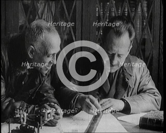 Portuguese Airmen Sacadura Cabral and Gago Coutinho Looking at a Map, 1922. Creator: British Pathe Ltd.