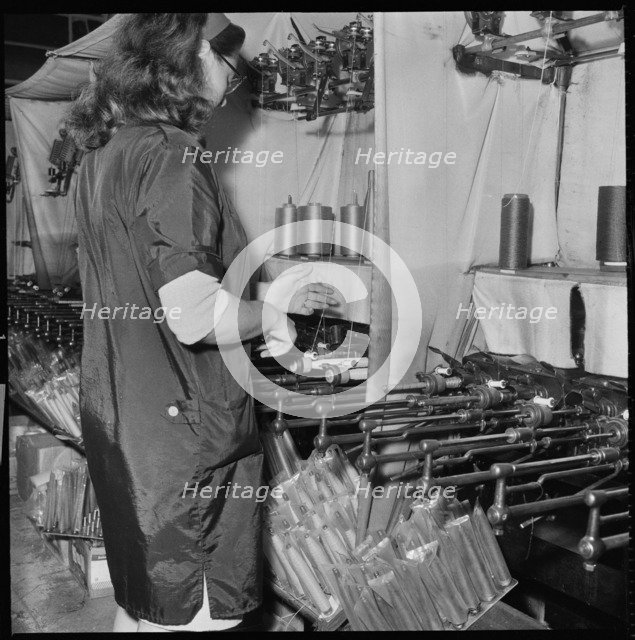 Woman operating a cop winding frame in a textile mill, 1966-1974. Creator: Eileen Deste.