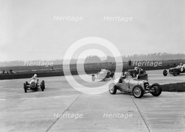 Racing cars taking a corner at Brooklands, Surrey, c1930s. Artist: Bill Brunell.