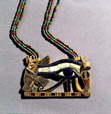 A pendant from the tomb of Tutankhamun in the form of a 'Wedjat eye', symbol of protection, flanked by the vulture goddess, Nekhbet and the snake goddess Wadjet, protectors of Upper & Lower Egypt.