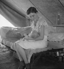 Young migrant mother with six weeks old baby born in a hospital, near Westley, CA, 1939. Creator: Dorothea Lange.