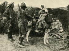 Australian soldier giving water to a Turkish family, First World War, 1915-1916, (c1920). Creator: Unknown.