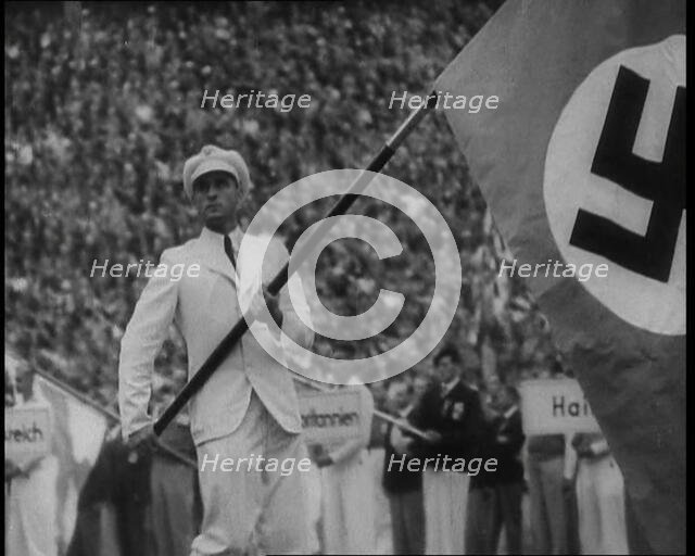 Man Holding the Flag of Nazi Germany, 1936. Creator: British Pathe Ltd.