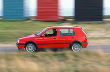 Man driving 1996 Vokswagen Golf Gti. Artist: Unknown.