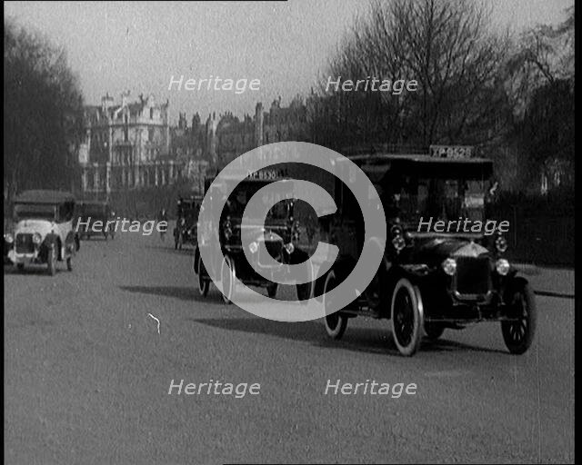 Taxis Drive Down a London Street, 1924. Creator: British Pathe Ltd.