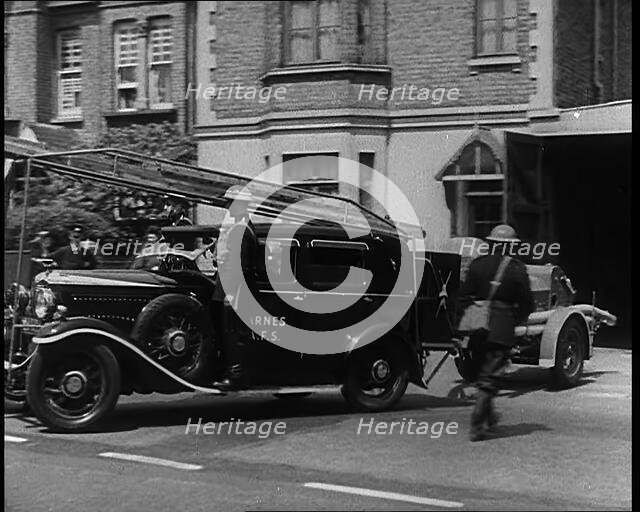 A Car With a Fire Hose attached Driving Away, 1940. Creator: British Pathe Ltd.