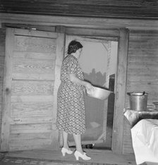 Tobacco sharecropper's wife disposing of dishwater..., Person County, North Carolina, 1939. Creator: Dorothea Lange.