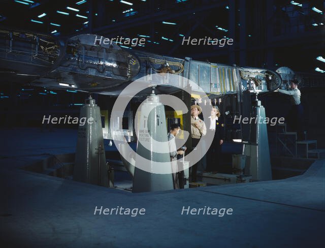 Working on wing of Consolidated Liberator..., Consolidated Aircraft Corp., Fort Worth, Texas, 1942. Creator: Howard Hollem.