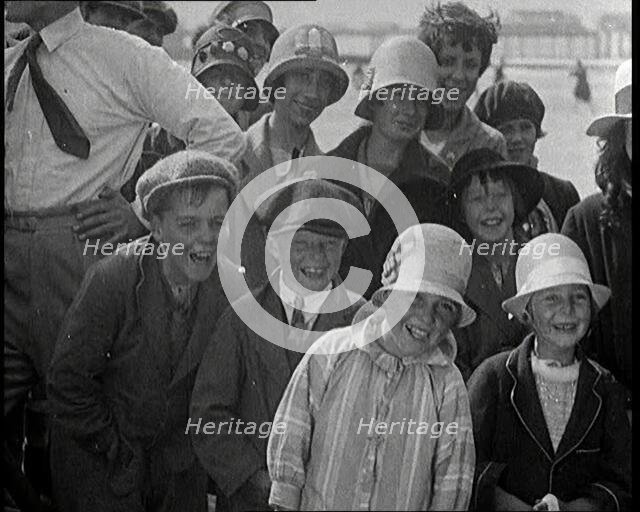 A Group of Male and Female Children Laughing as They Are Watching a Film Being Made, 1920s. Creator: British Pathe Ltd.