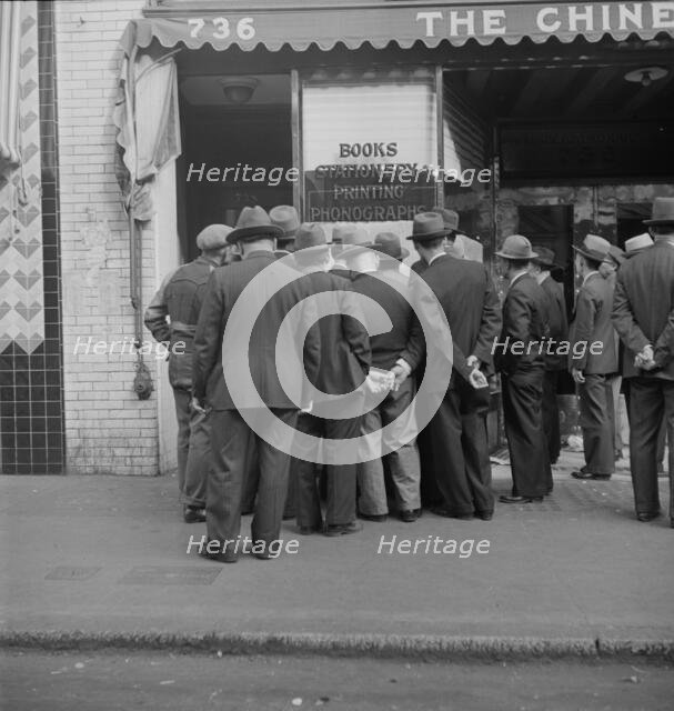 In front of the local paper of San Francisco's Chinatown, 1938. Creator: Dorothea Lange.