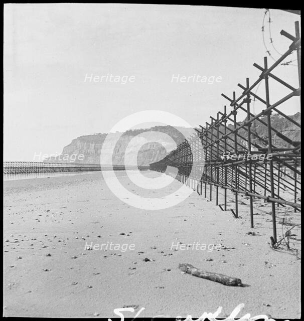 View looking south along the beach at Shanklin, showing Admiralty scaffolding, Isle Of Wight, 1945. Creator: George R Long.