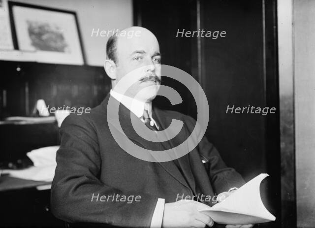 N. Longworth seated with book, 1911. Creator: Bain News Service.