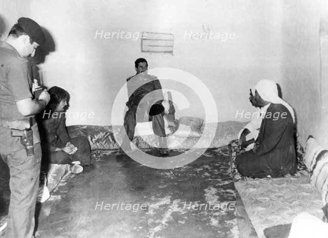 Saddam Hussein visiting a peasant house in Basra, Iraq, 1987. Artist: Unknown