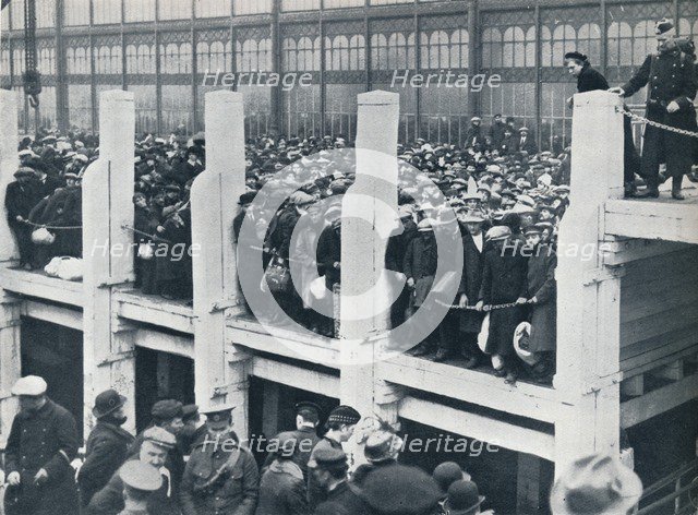 Belgian refugees on the harbour at Ostend waiting for a boat to take them to England, 1914.