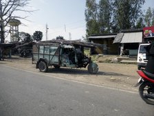 Tutuk carrying load of steel rods on roof, India 2017. Creator: Unknown.