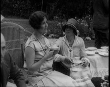 A Group of People Drinking Tea and Eating Cakes in the Garden, 1926. Creator: British Pathe Ltd.