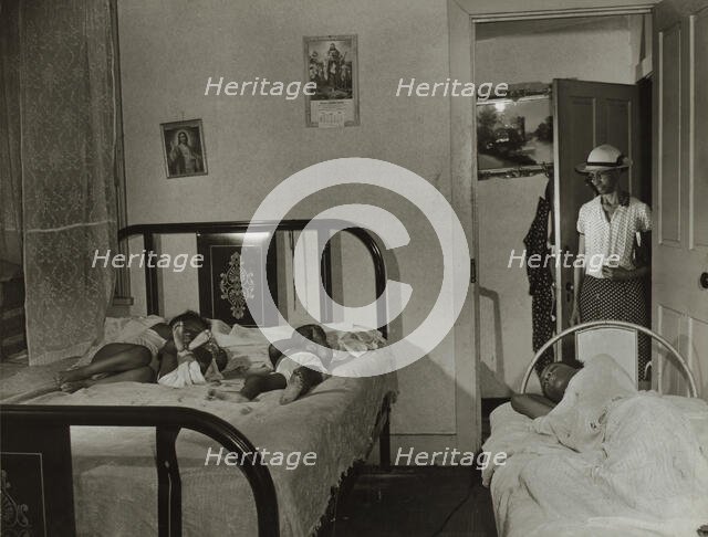 Mrs. Ella Watson, a government charwoman going home..., Washington, D.C., 1942. Creator: Gordon Parks.