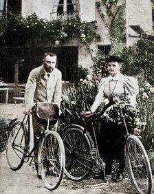Pierre and Marie Curie, French physicists, preparing to go cycling. Artist: Unknown.
