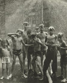 Group of children, mostly boys, gathered under sprinkler, in East Harlem, New York City, 1947 - 1951 Creator: Romulo Lachatanere.
