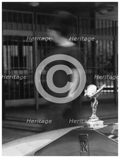 Woman walking past a Rolls-Royce. Artist: Unknown