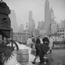 Icing barrels of fish at the Fulton fish market, New York, 1943. Creator: Gordon Parks.