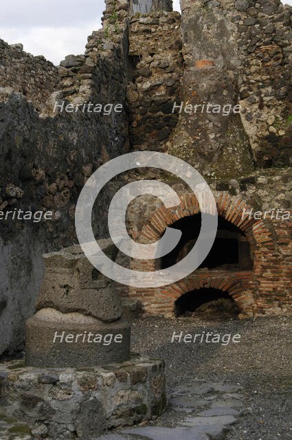 Millstone and oven in the pistrinum, (bakery), Pompeii, Italy, 2009.  Creator: LTL.