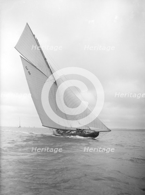 The 12 Metre sailing yacht 'Rollo' racing upwind, 1911. Creator: Kirk & Sons of Cowes.