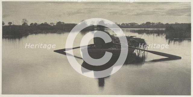 Rowing Home the Schoof-Stuff (from Life and Landscape on the Norfolk Broads, 1886, plate XXI), 1886. Creator: Peter Henry Emerson (British, 1856-1936); Sampson Low, Marston, Seale and Riverton (with T.F. Goodall).