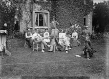 People playing music in a garden, c1896-c1920. Artist: Alfred Newton & Sons
