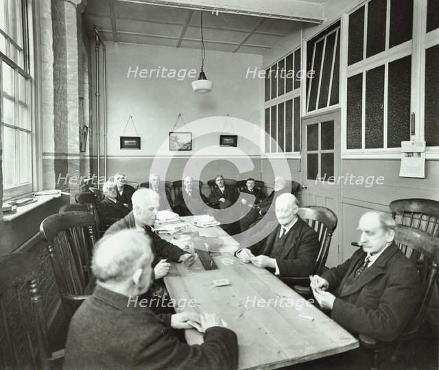 Pensioners playing cards in the Men's Day Room, Lambeth Home for Aged Poor, London, 1935. Artist: Unknown.