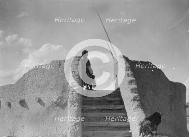 Tewa Indian guard at top of the kiva stairs, San Ildefonso, New Mexico, c1905. Creator: Edward Sheriff Curtis.