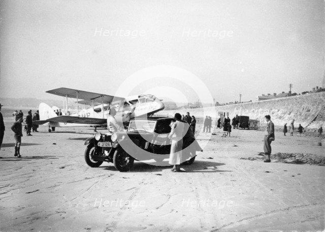 Riley Kestrel and a Dragon aircraft on a beach, 1934. Artist: Unknown