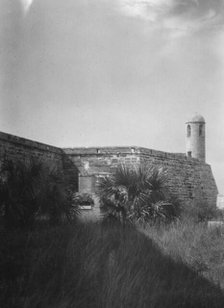 Walls and round tower by the water, Castillo de San Marcos, St. Augustine, Florida, c1920-c1926. Creator: Arnold Genthe.