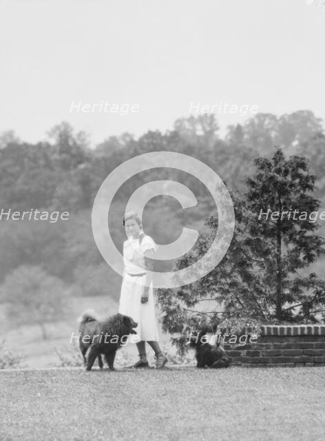 Brady, Victoria, Miss, with dogs, standing outdoors, 1931 July 14. Creator: Arnold Genthe.