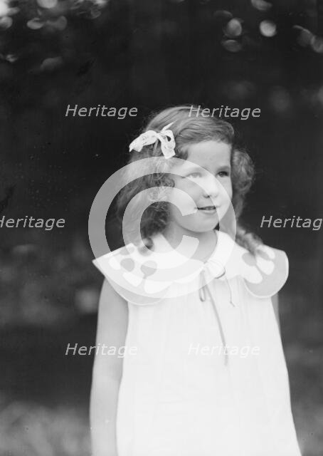 Daughter of W.G. Kimball, standing outdoors, between 1911 and 1942. Creator: Arnold Genthe.