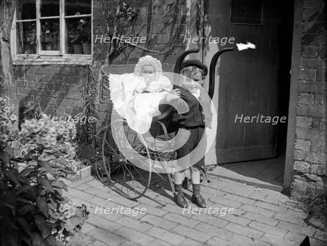 Child with a baby in a pram, Hellidon, Northamptonshire, 1900. Artist: A Newton