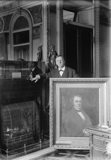 Daniels, Josephus, Secretary of The Navy, 1913-1921 with Painting of Secretary of The Navy..., 1913. Creator: Harris & Ewing.