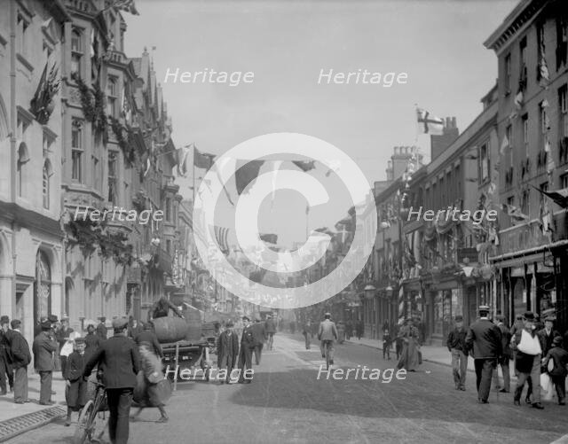Cornmarket Street decorated with flags and banners for a royal visit, Oxford, Oxfordshire, 1897.  Creator: Henry Taunt.