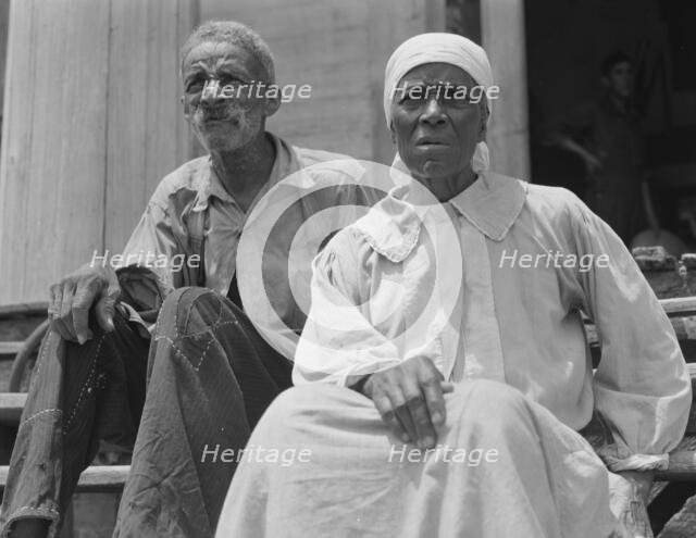Ex-slave and wife who live in a decaying plantation house, Greene County, Georgia, 1937. Creator: Dorothea Lange.