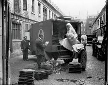 Ambulance Column depot, 9 Gower Street, London: loading up the blanket bus in Gower Mews, 1918. Creator: Unknown.