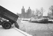 The snow clearance squad tip snow into the harbour, Landskrona, Sweden 1958. Artist: Unknown