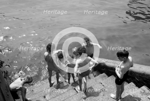 Children bathing in the River Thames, Tower Pier approach, Stepney, London, c1945-c1965. Artist: SW Rawlings