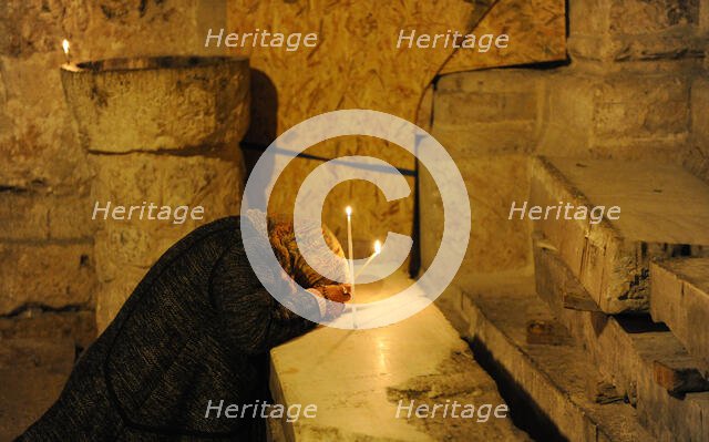Woman praying, Basilica of the Holy Sepulchre, Jerusalem, Israel, 2014.  Creator: LTL.