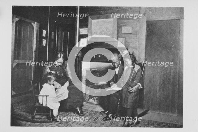 An African American family; Reading books, 1922. Creator: Unknown.