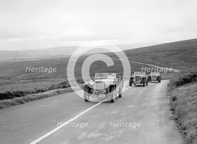 Three MG TAs competing at the MCC Torquay Rally, July 1937. Artist: Bill Brunell.