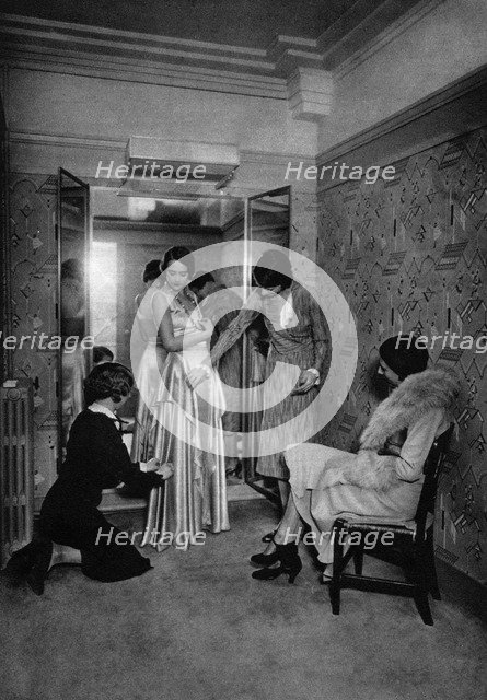 Trying on a dress at a great dressmakers, Paris, 1931.Artist: Ernest Flammarion