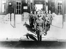 German army officer leading his company onto a railway station platform, Paris, August 1940. Artist: Unknown