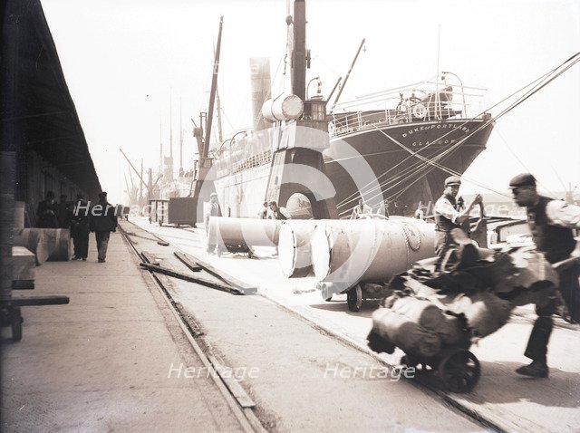 Unloading rolls of paper from a ship, London, c1905. Artist: Unknown